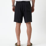 The Holiday Linen Short in black — back view showing the elasticated waistband and pocket