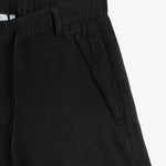 The Holiday Linen Short in black — close-up of the side pocket with tonal embroidery