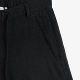 The Holiday Linen Short in black — close-up of the side pocket with tonal embroidery