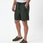 The Holiday Linen Short in dark khaki — side-front view with drawstring waist