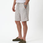The Holiday Linen Short in natural — side view worn with green suede clogs