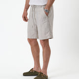 The Holiday Linen Short in natural — side view worn with green suede clogs