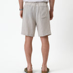 The Holiday Linen Short in natural — back view showing the single rear pocket