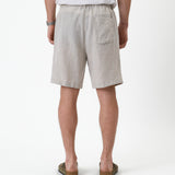 The Holiday Linen Short in natural — back view showing the single rear pocket