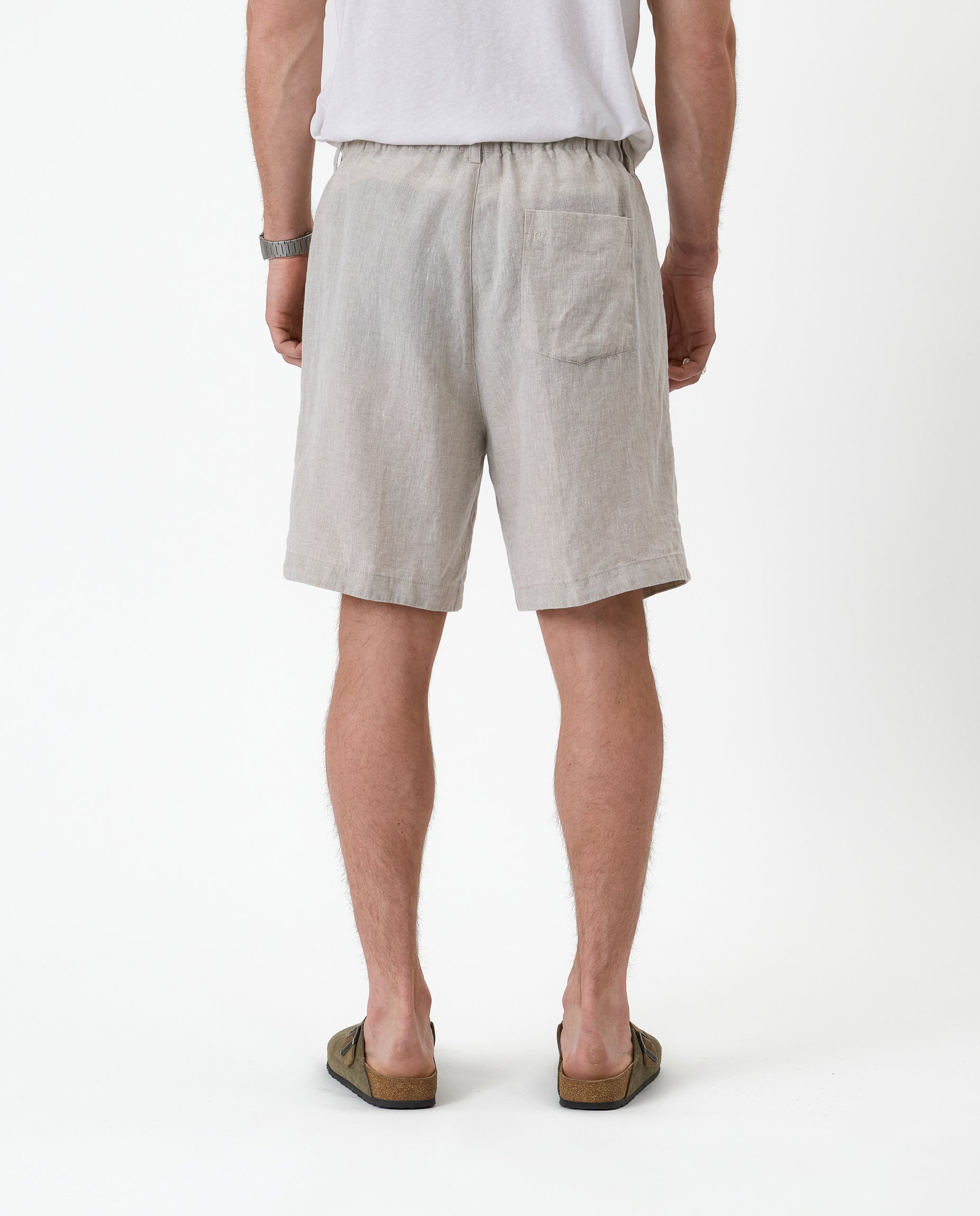 The Holiday Linen Short in natural — back view showing the single rear pocket