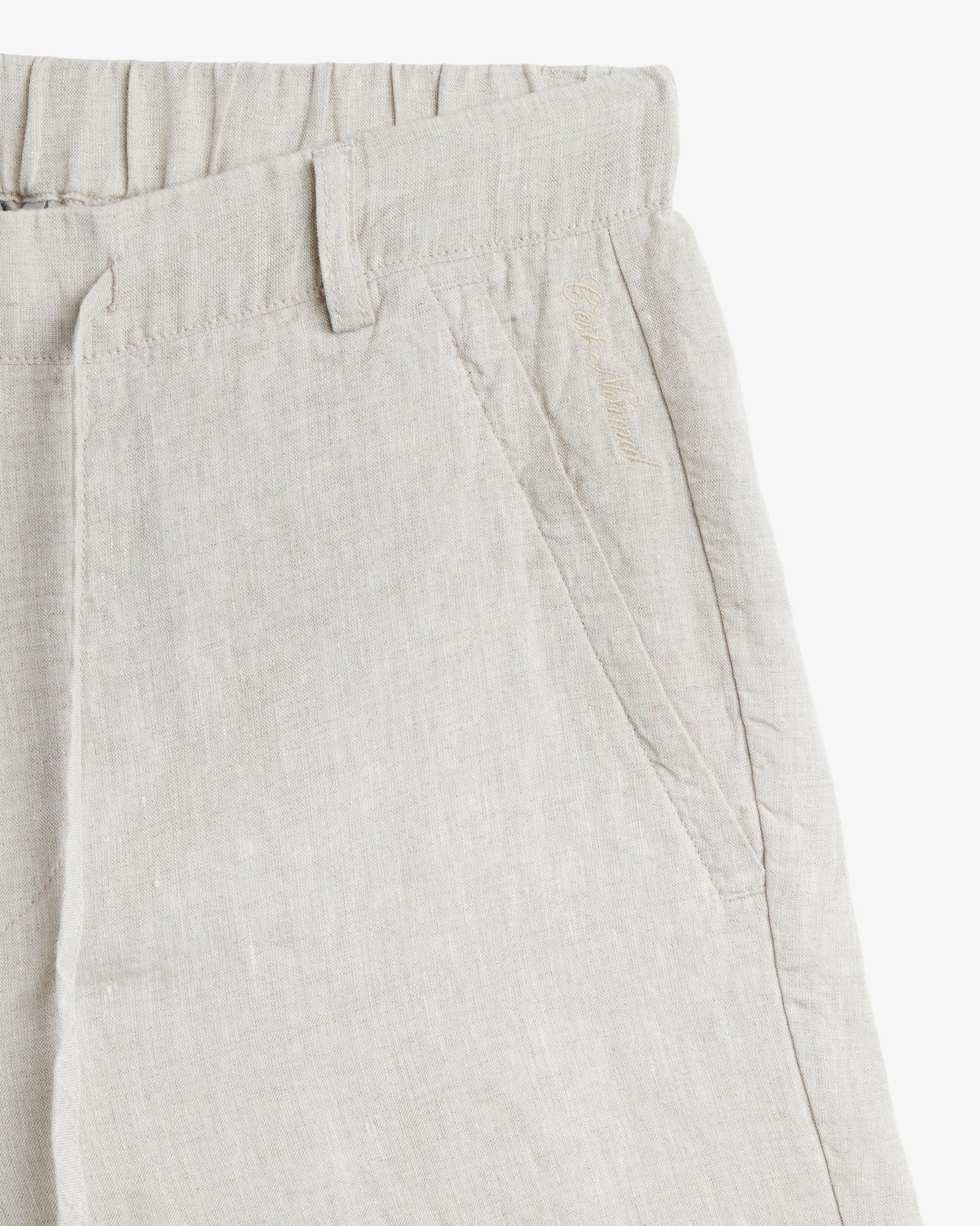 The Holiday Linen Short in natural — featuring tonal C'est normal embroidery near the pocket