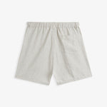 The Holiday Linen Short in natural — back view showing the rear pocket