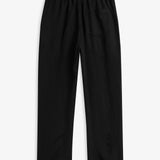 The Holiday Linen Trouser in black — back view with an elastic waistband and single pocket