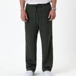 The Holiday Linen Trouser in dark khaki — front view with a drawstring waist