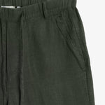 The Holiday Linen Trouser in dark khaki — close-up of the elasticated waistband and pocket