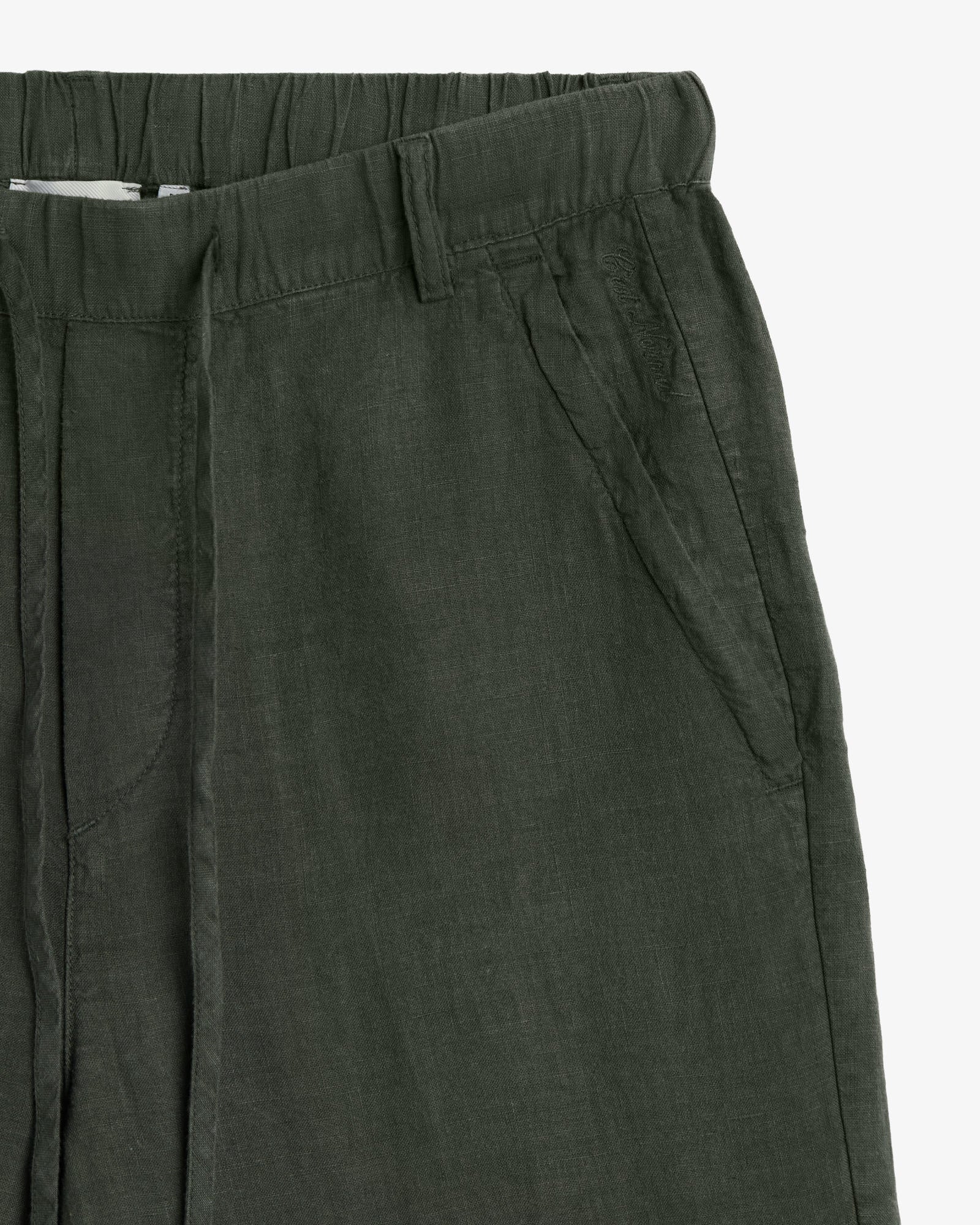 The Holiday Linen Trouser in dark khaki — close-up of the elasticated waistband and pocket