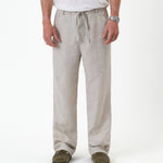 The Holiday Linen Trouser in natural — front view showing the drawstring waist