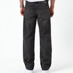 The Jeans Relaxed Straight Fit in faded black — back view with a rubber patch at the waist