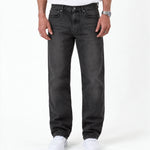 The Jeans Relaxed Straight Fit in faded black — worn with white sneakers