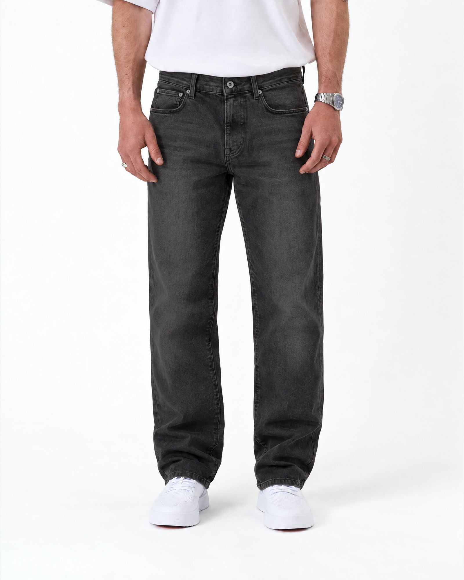 The Jeans Relaxed Straight Fit in faded black — worn with white sneakers