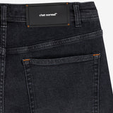 The Jeans Relaxed Straight Fit in faded black — close-up of the back waist patch and pocket