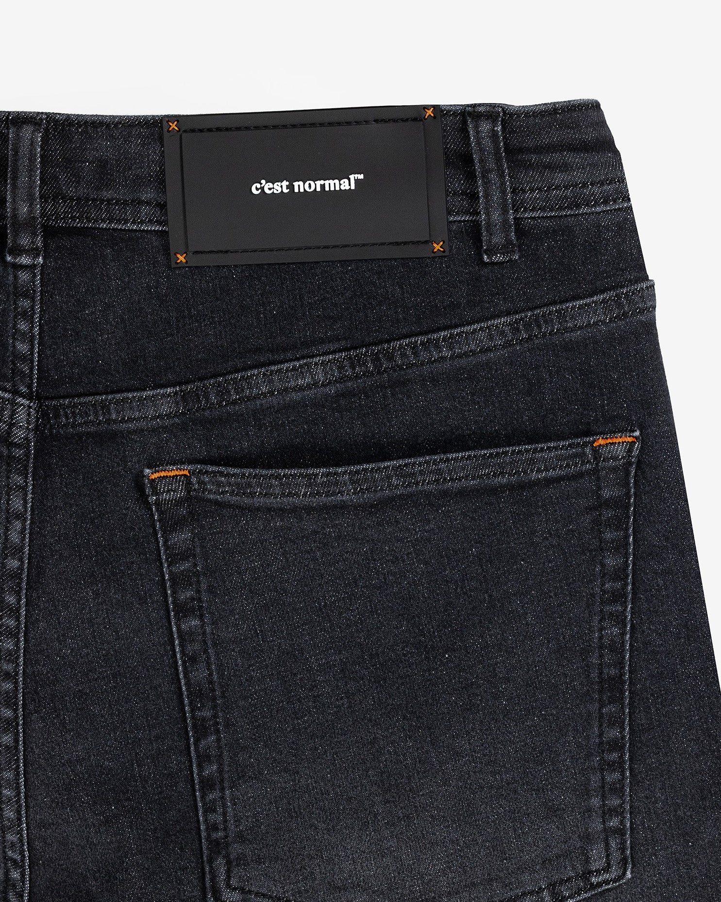 The Jeans Relaxed Straight Fit in faded black — close-up of the back waist patch and pocket