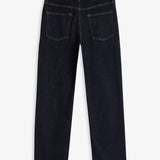 A back view of The Jeans Relaxed Straight Fit in Rinse Wash, laid flat on a white background. The image highlights the straight leg silhouette, two back pockets, subtle orange accent stitching, and the rubber patch at the back waist with the c'est normal logo.