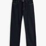 A front view of The Jeans Relaxed Straight Fit in Rinse Wash, laid flat on a white background. The image highlights the straight leg silhouette, zip fly with top button, front pockets, subtle orange accent stitching, and a black drawstring detail at the waist.
