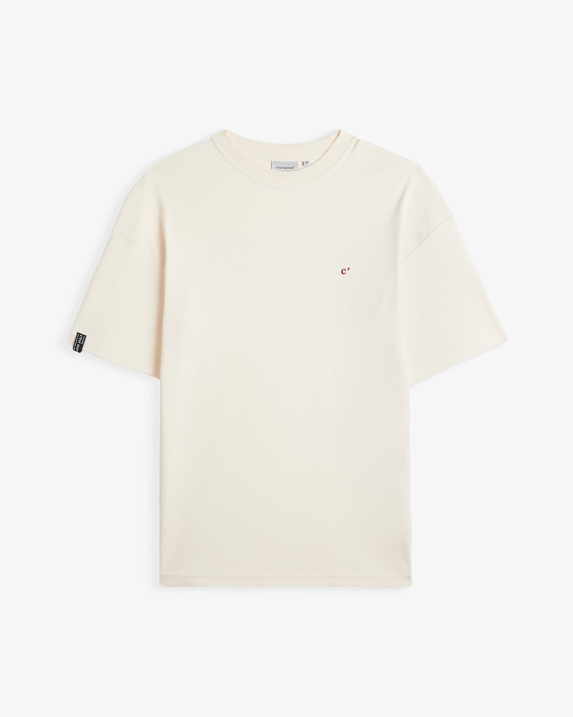 The Oversized Printed T-shirt in cream and red — front view with a small red chest logo