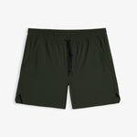 A front view of The Shorts in khaki, laid flat on a white background. The image highlights the elasticated waistband with a black drawstring, side pockets, notched hem, and a subtle c'est normal logo on the left leg.