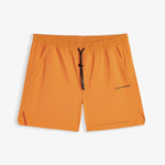A front view of The Shorts in orange peel, laid flat on a white background. The image highlights the elasticated waistband with a black drawstring, side pockets, notched hems, and the printed c'est normal logo.