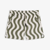 A front view of The Shorts in an olive curl stripe pattern, laid flat on a white background. The image highlights the wavy design, elasticated waistband with a drawstring, and notched hem.