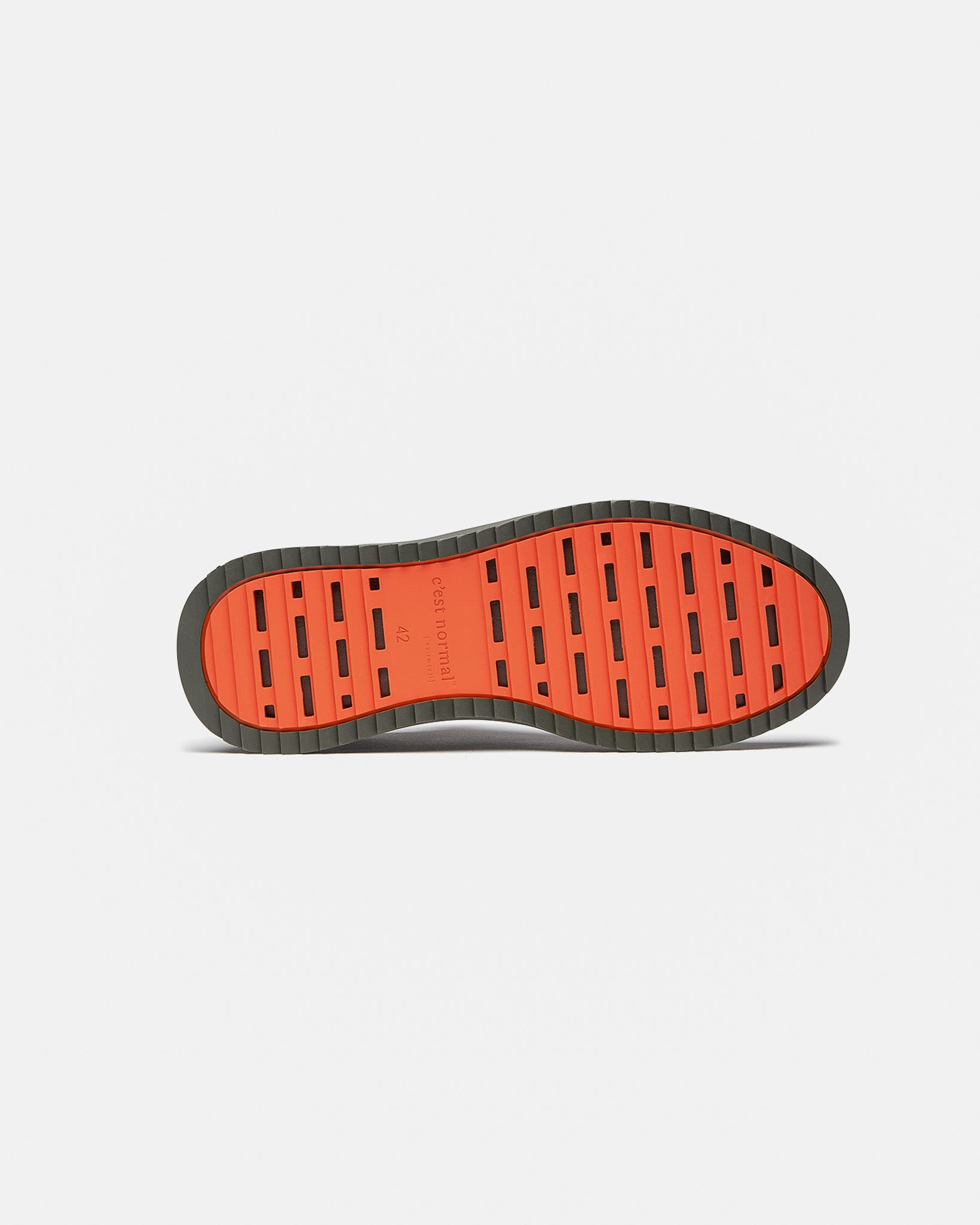 The Sneakers 2.0 in khaki — bottom view showing the original orange rubber grid sole