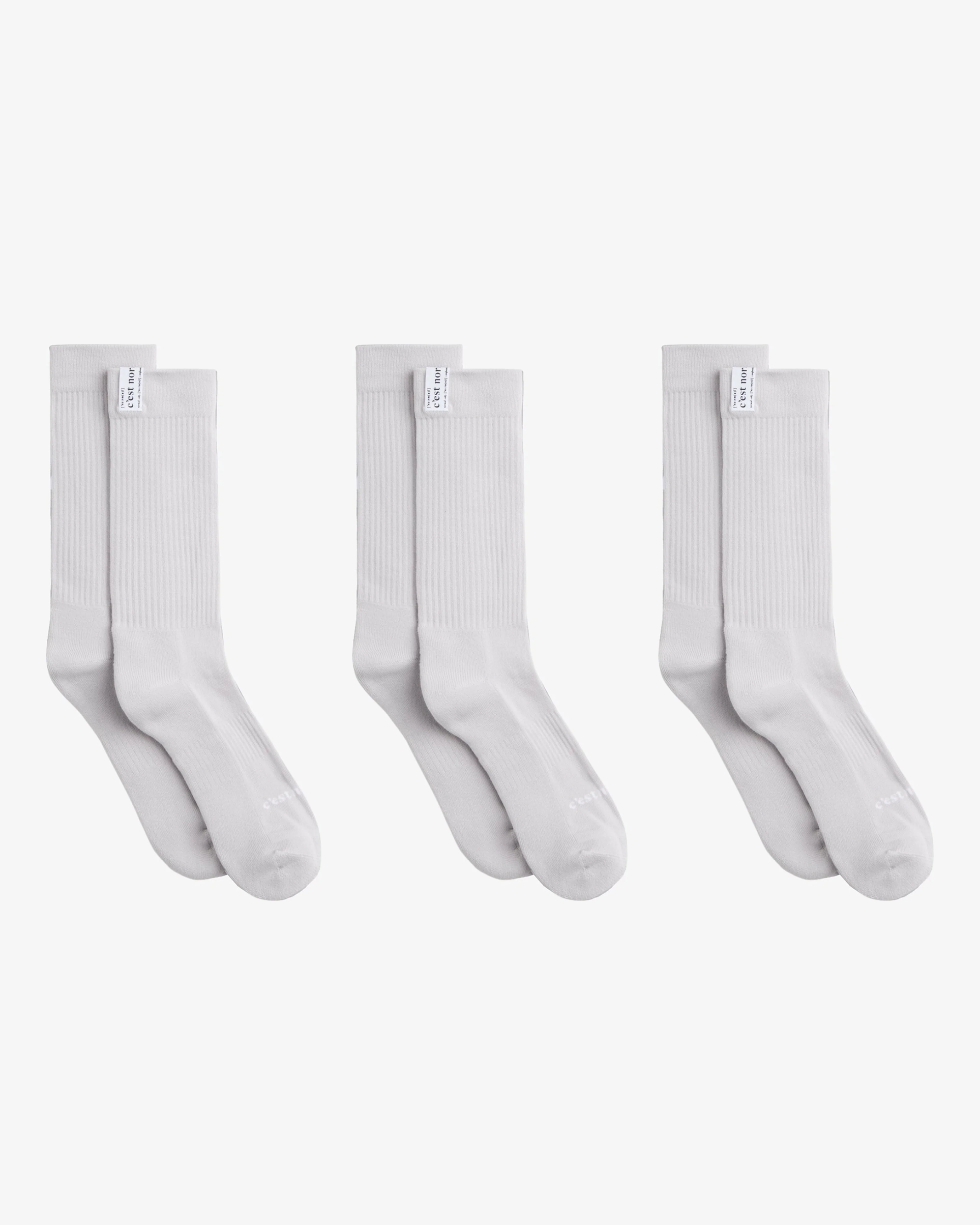 The Socks 3-pack in grey — three pairs of mid-calf socks showing ribbed cuffs and logo tags