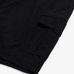 The Board Shorts in black — close-up of the cargo pocket with a drainage grommet