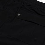 The Board Shorts in black — back pocket detail with a small logo tag and drainage eyelet
