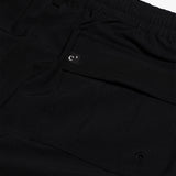 The Board Shorts in black — back pocket detail with a small logo tag and drainage eyelet
