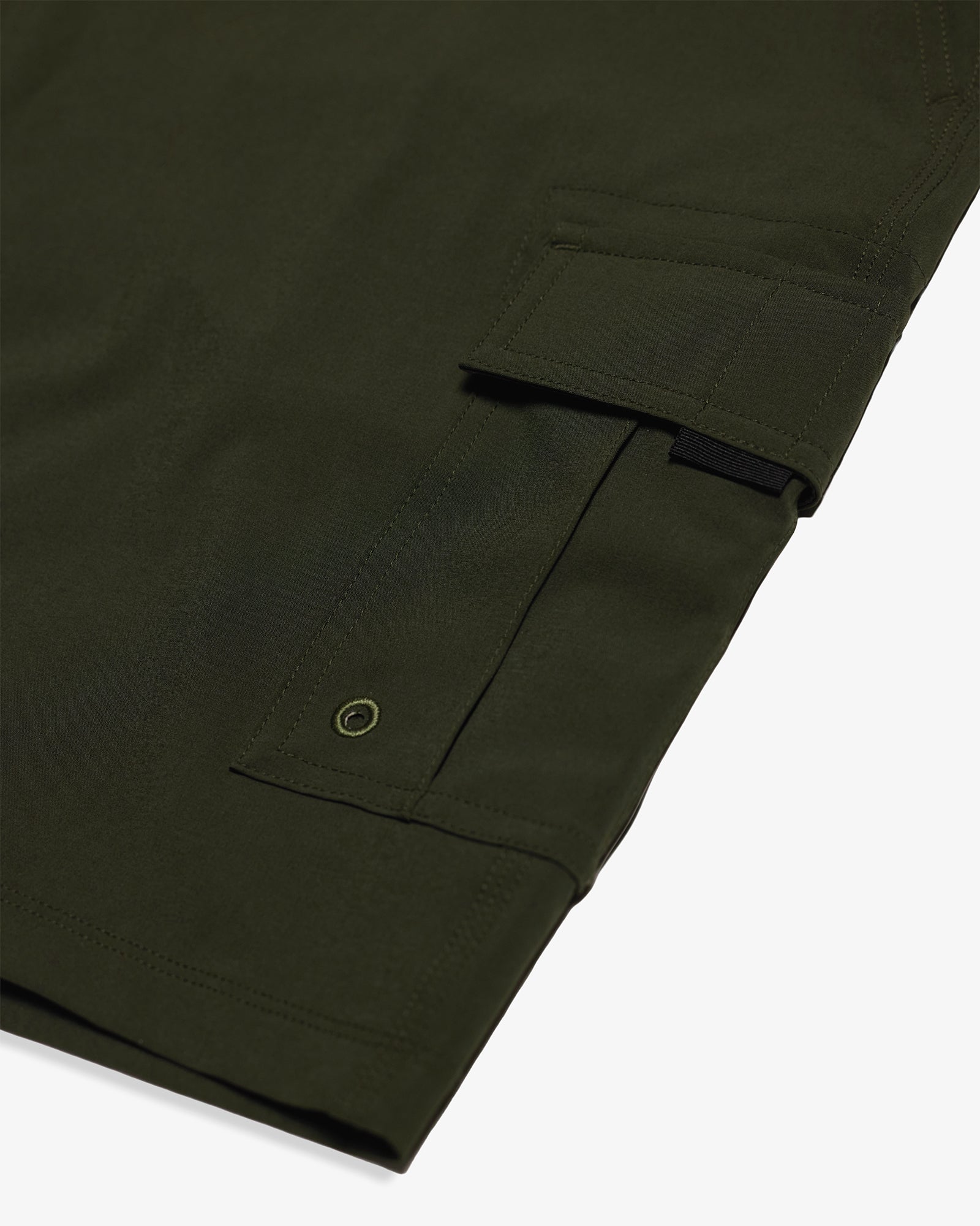 The Board Shorts in khaki — close-up of the side pocket with drainage eyelet