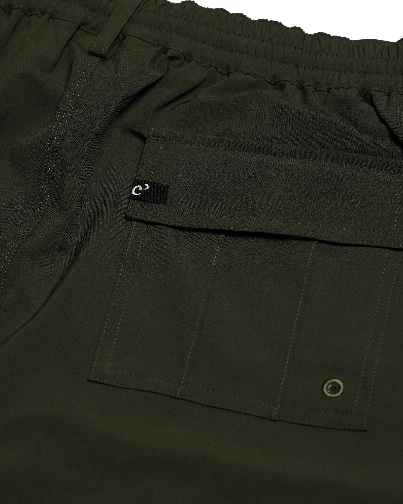 The Board Shorts in khaki — close-up of the back flap pocket and drainage eyelet