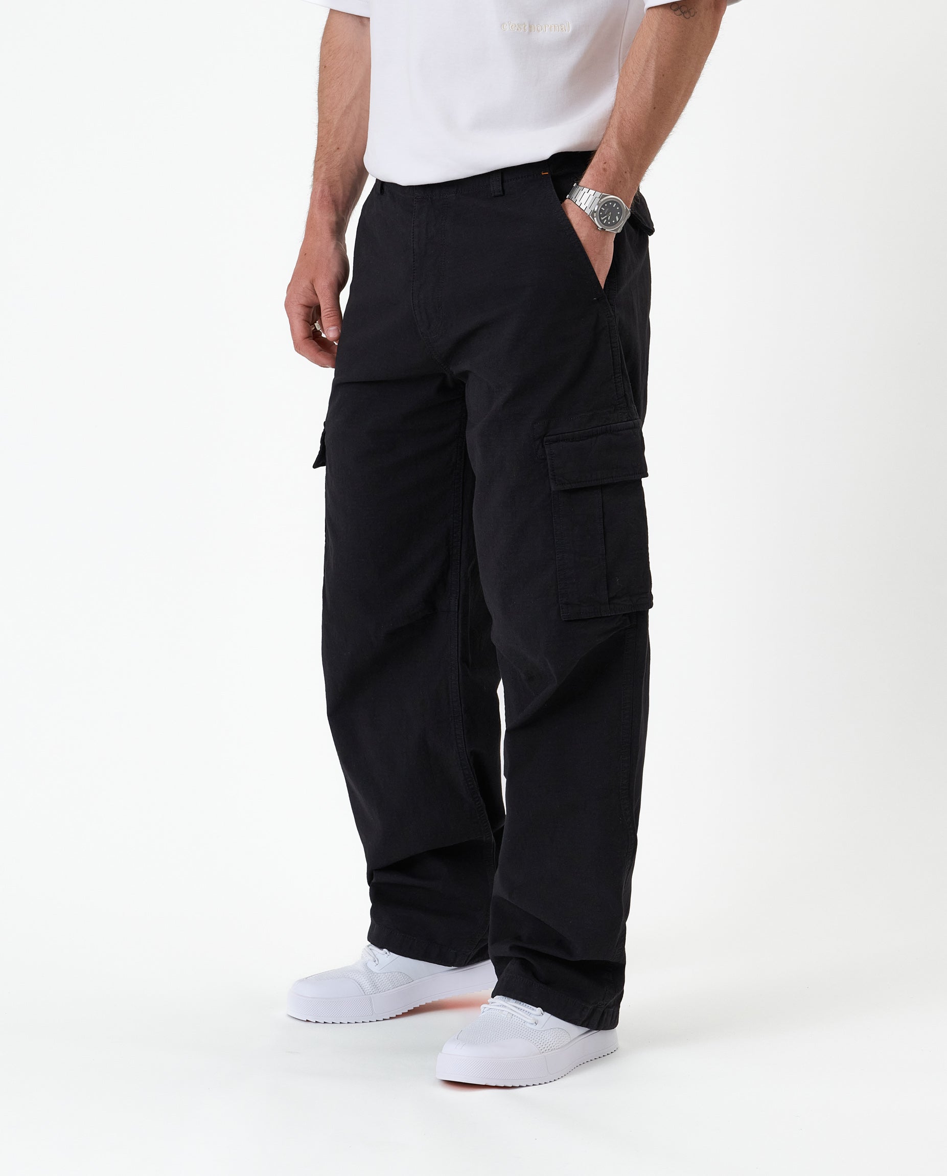 The Monterey Cargo Pant in black — side view showing the cargo flap pocket