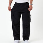 The Monterey Cargo Pant in black — stretching the fabric to show the flexible comfort stretch