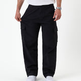 The Monterey Cargo Pant in black — stretching the fabric to show the flexible comfort stretch