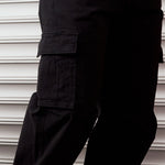The Monterey Cargo Pant in black — close-up of the angled cargo flap pocket