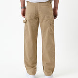 The Carpenter Pant in beige — back view showing utility pockets and hammer loop