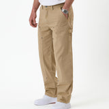 The Carpenter Pant in beige — side view showing the hammer loop and utility pockets