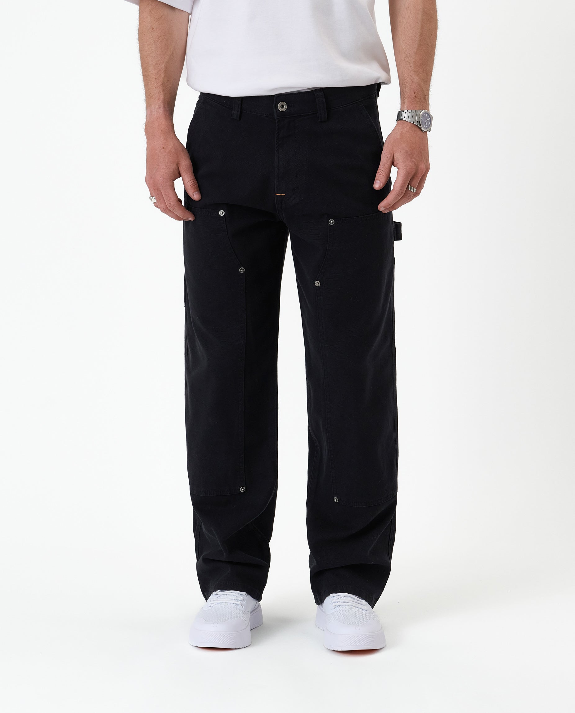The Carpenter Pant in black — front view showing the double knee panels and rivets