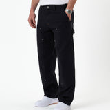 The Carpenter Pant in black — side view showing the hammer loop and copper-toned rivets