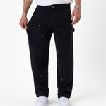 The Carpenter Pant in black — fabric being pulled to show the flexible stretch material