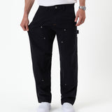 The Carpenter Pant in black — fabric being pulled to show the flexible stretch material