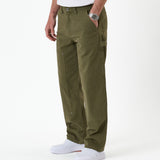 The Carpenter Pant in olive green — side view showing the double knee paneling