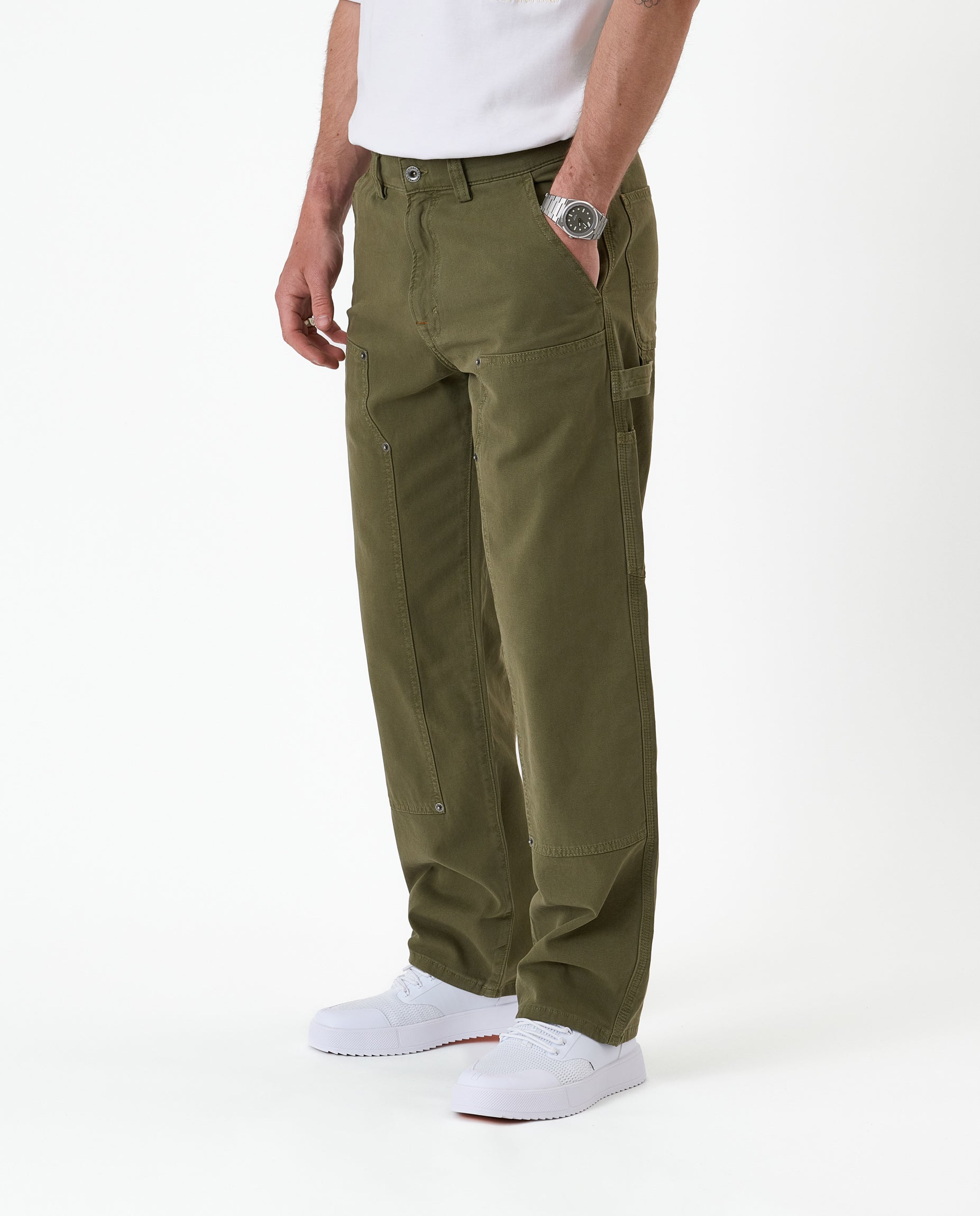 The Carpenter Pant in olive green — side view showing the double knee paneling