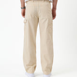 The Carpenter Pant in sand — back view with utility pockets and hammer loop