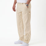 The Carpenter Pant in sand — side view featuring the hammer loop and white sneakers