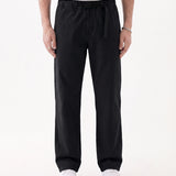 The Chamonix Chino in black — front view showing the integrated belt and relaxed fit