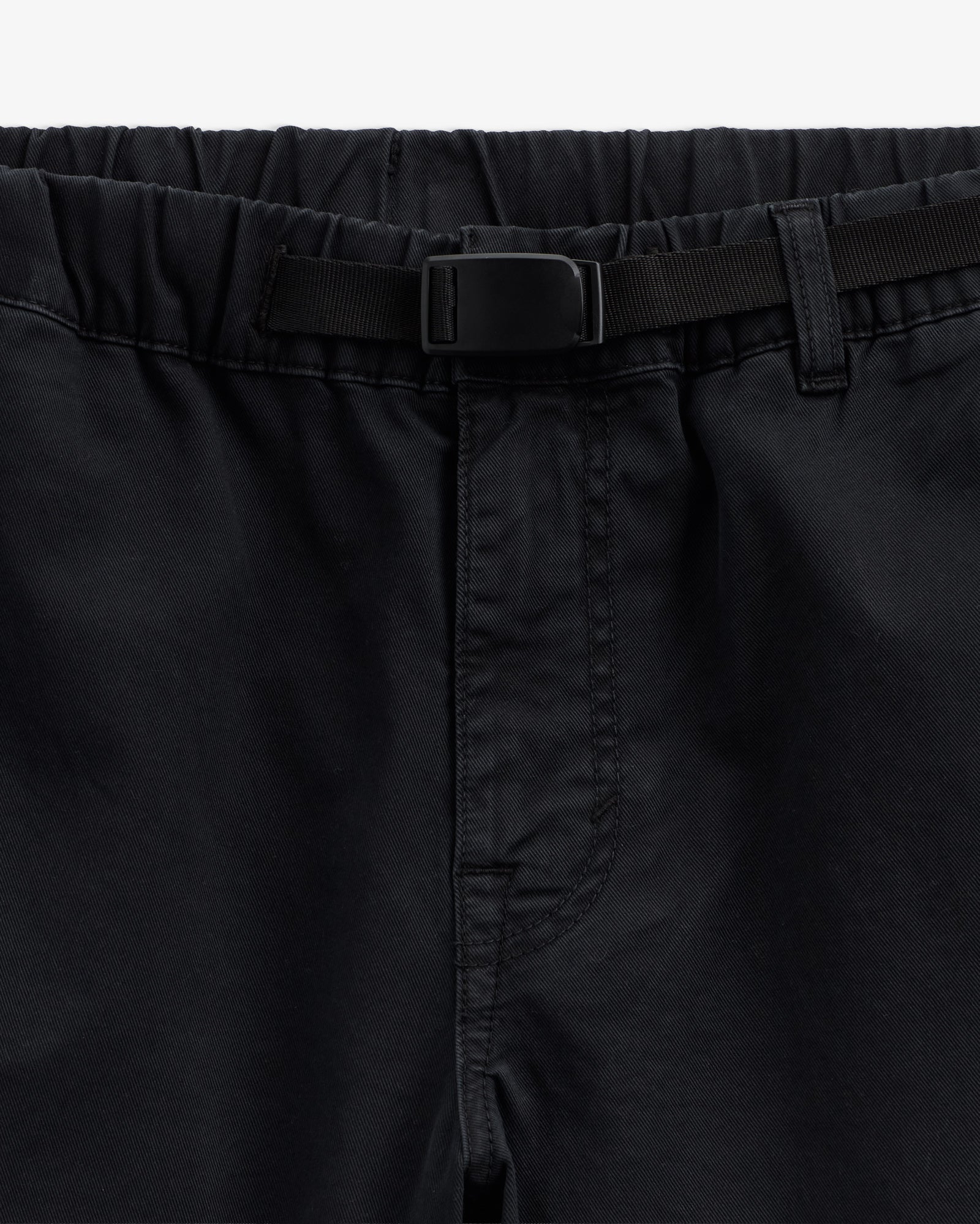 The Chamonix Chino in black — close-up of the waistband and integrated belt buckle
